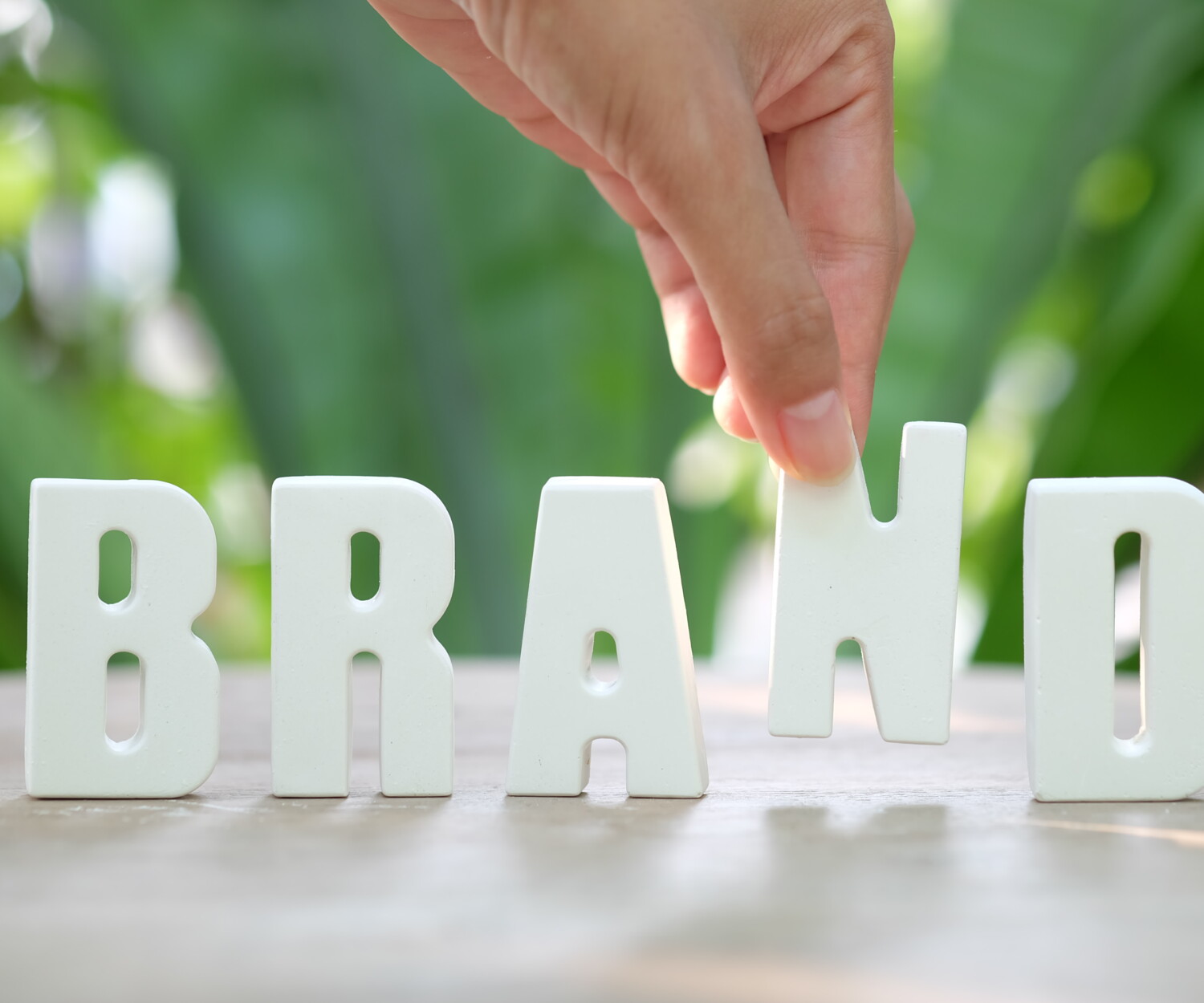 Hand arrange white letters BRAND